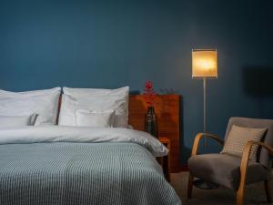 a bedroom with a bed and a lamp at Art Hotel Prague in Prague