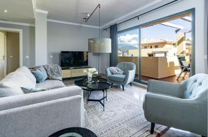 a living room with a couch and chairs and a tv at LA-Beautiful 3 bedroom Penthouse close to sea in Marbella