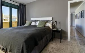 a bedroom with a large bed and a window at LA-Beautiful 3 bedroom Penthouse close to sea in Marbella +42 photos