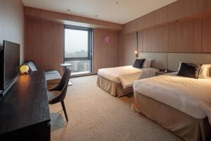 Postel nebo postele na pokoji v ubytování Yokohama Tokyu REI Hotel