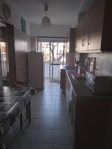 a kitchen with a table and a counter top at Casa do MIGUEL- 2 BEDROOM APARTMENT in Faro