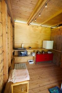 een keuken in een houten huisje met een rode kast bij Bergliot Bed & Breakfast in Hundested