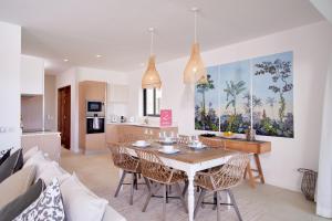 a kitchen and dining room with a table and chairs at Nautilya Apartment by LOV in Pointe aux Cannoniers