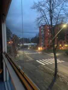 a view from a window of a street with a tree at Modern Apartment nearby Airport in Vantaa