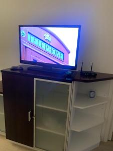 a tv on top of a cabinet with a video game on it at Modern Apartment nearby Airport in Vantaa