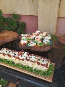 two trays of food on display in a store at Café Palace Hotel in Três Pontas