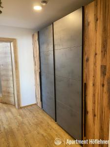 a room with a large metal closet with a wooden floor at Appartment Höflehner - Sommercard in Großsölk