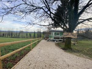a rv parked next to a fence with a road out sign at Roul Poul in Malbrans