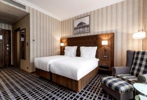 Postel nebo postele na pokoji v ubytování Hotel Grand City Wrocław