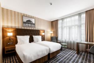 Postel nebo postele na pokoji v ubytování Hotel Grand City Wrocław