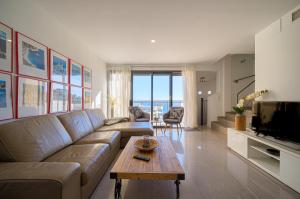 a living room with a couch and a table at Casa Vistamar in Altea