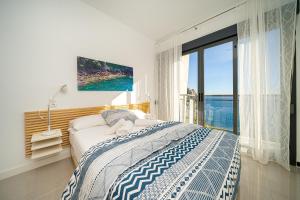 a bedroom with a bed and a large window at Casa Vistamar in Altea +42 photos