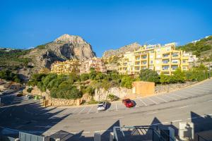 a city with cars parked in a parking lot at Casa Vistamar in Altea