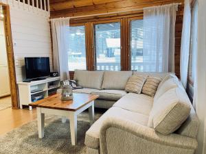 a living room with a couch and a table at Lomasärkkä1 in Kalajoki