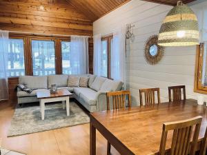a living room with a couch and a table at Lomasärkkä1 in Kalajoki