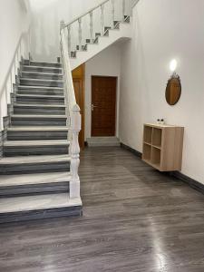 a staircase in a white room with a wooden door at Apartamento en Olula del Río in Olula del Río