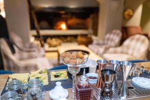 a table with a plate of food and wine glasses at Grand Hôtel Courchevel 1850 in Courchevel