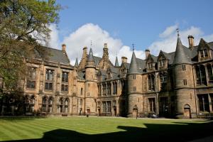 an old castle with a grass yard in front of it at The Georgian House in Glasgow