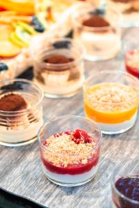 a bunch of different types of food in glass bowls at Hotel Colombo in Lido di Jesolo