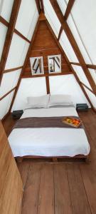 a bedroom with a bed in a attic at Primitivo glamping buzios in Búzios