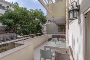 a balcony with a table and chairs on a building at Rothschild Area - One BDR with a Big terrasse in Tel Aviv