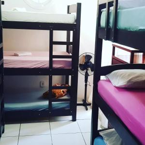 a room with two bunk beds with a ladder at Taberna Hostel in Cabo Frio +36 photos