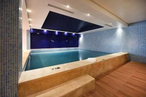 a swimming pool with a tub in a bathroom at Flower Town Hotel & Spa in Rabat