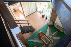 an overhead view of a living room with a staircase and a floor at Caiowa Floripa guesthouse in Florianópolis