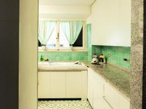 a kitchen with a sink and a window at Villa LO SCHIOPPO vista mare in Marciana Marina