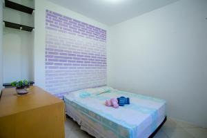 a bedroom with a bed with two stuffed animals on it at Caiowa Floripa guesthouse in Florianópolis