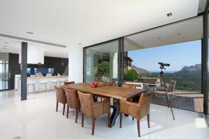 a dining room with a table and chairs and a camera at Casa Liebre in Pollença