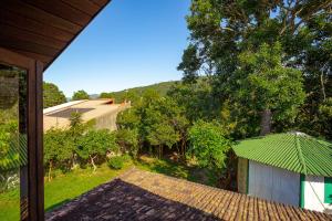 an outside view of a house with a green roof at Caiowa Floripa guesthouse in Florianópolis