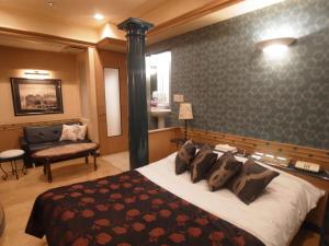 a hotel room with a bed and a couch at Hotel VINO Adult Only in Kawaguchi +37 photos