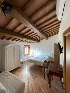 a bedroom with a bed and a desk and a table at Affittacamere Il Vecchio Mandorlo in Montemagno