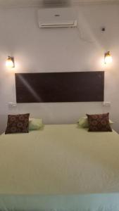 a bedroom with a large bed with two pillows at Monara Backpacker Inn Unawatuna in Unawatuna