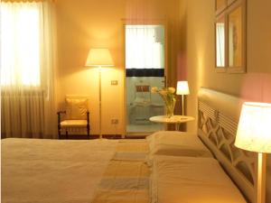 Säng eller sängar i ett rum på Casa Margherita
