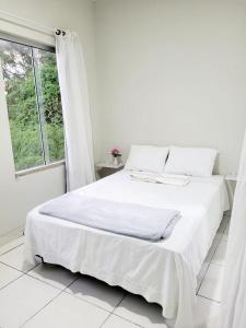 A bed or beds in a room at Sobrado 6 amplo e confortável em condomínio