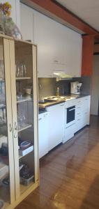 a kitchen with white cabinets and a stove top oven at Ranta Antti 3 in Inari