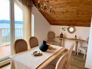 a dining room with a table and a view of the ocean at Casa de oro Alma in Sozopol