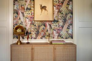 a table with a picture of a wolf on a wall at Boutique Hotel Bellevue Lermoos in Lermoos +42 photos