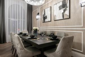 a dining room with a black table and chairs at Luxury Georgian City Retreat - Hot Tub - Patio in Edinburgh