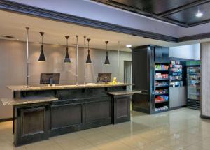 a bar in a grocery store with pendant lights at La Quinta by Wyndham Little Rock - Bryant in Bryant