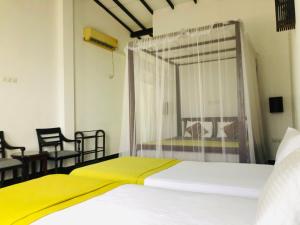 מיטה או מיטות בחדר ב-Saman Resort Yala