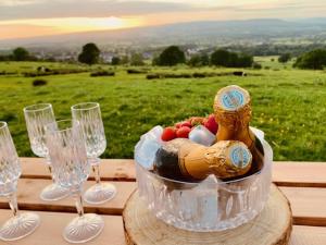 a table with wine glasses and a bowl of food at Ribble Valley Retreat in Langho +25 photos