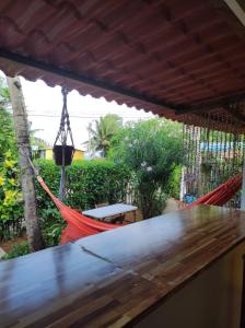 a hammock on the porch of a house at Flat Pico Vulcanico in Fernando de Noronha