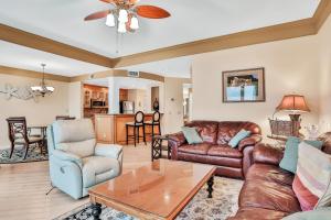 uma sala de estar com mobiliário de couro e uma mesa em Sea Dunes Penthouse em Fernandina Beach
