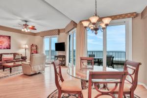 a dining room with a table and a view of the ocean at Sea Dunes Penthouse in Fernandina Beach