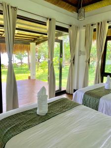 Katil atau katil-katil dalam bilik di Moon Beach Villas El Nido