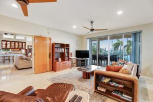 a living room with a couch and a table at Waterfront Wonder in Islamorada