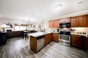 a large kitchen with wooden cabinets and a living room at The Bears Den in Helen